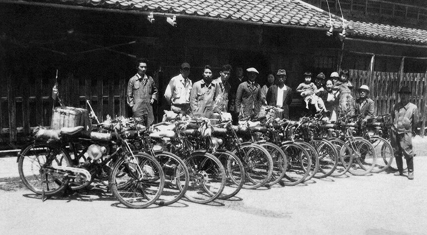 The image depicts the era of Honda in 1952 where Honda motor bike were used for transportation

