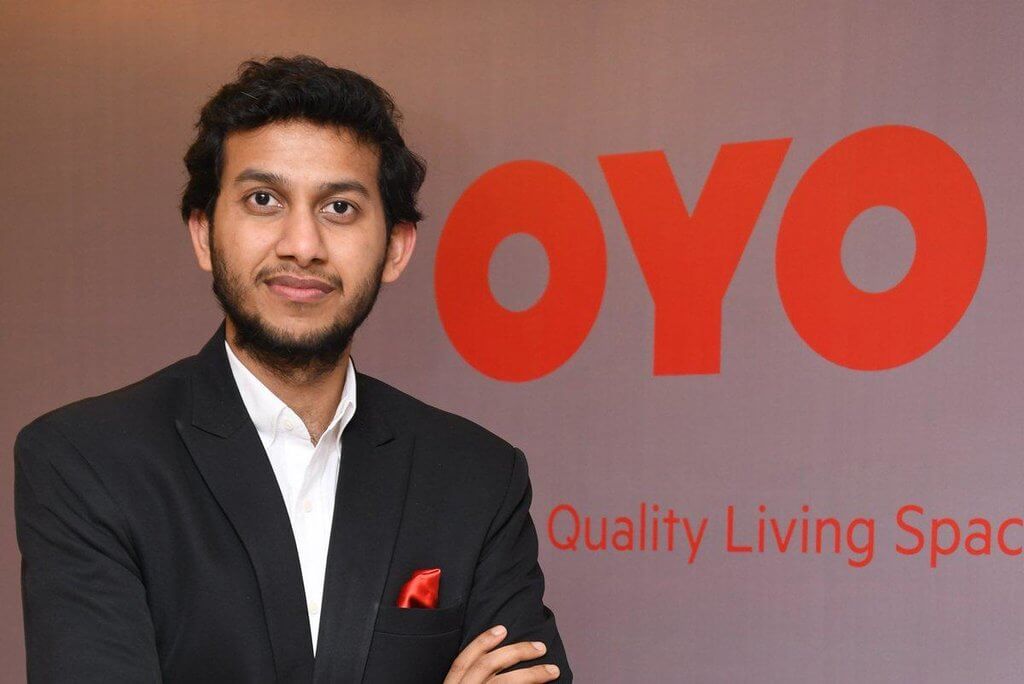 Ritesh-Agarwal-possing-with-oyo-rooms-logo-a-successful-startup