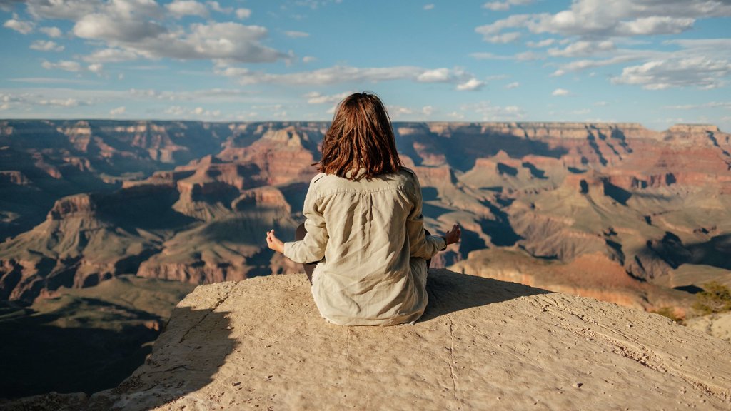 a girl doing meditation at mountain