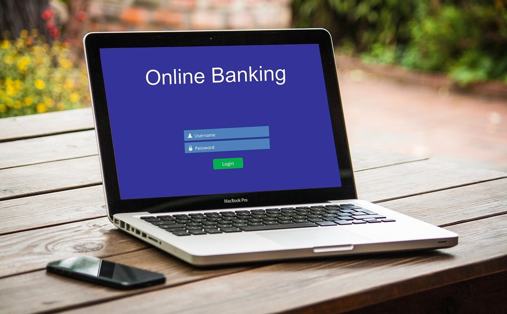 A picture is showing a laptop in which page of online banking is showing which is the vital part of fintech.