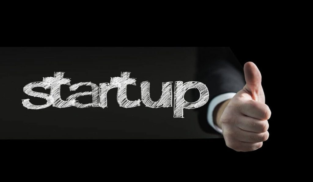 startup business written with a thumbs up