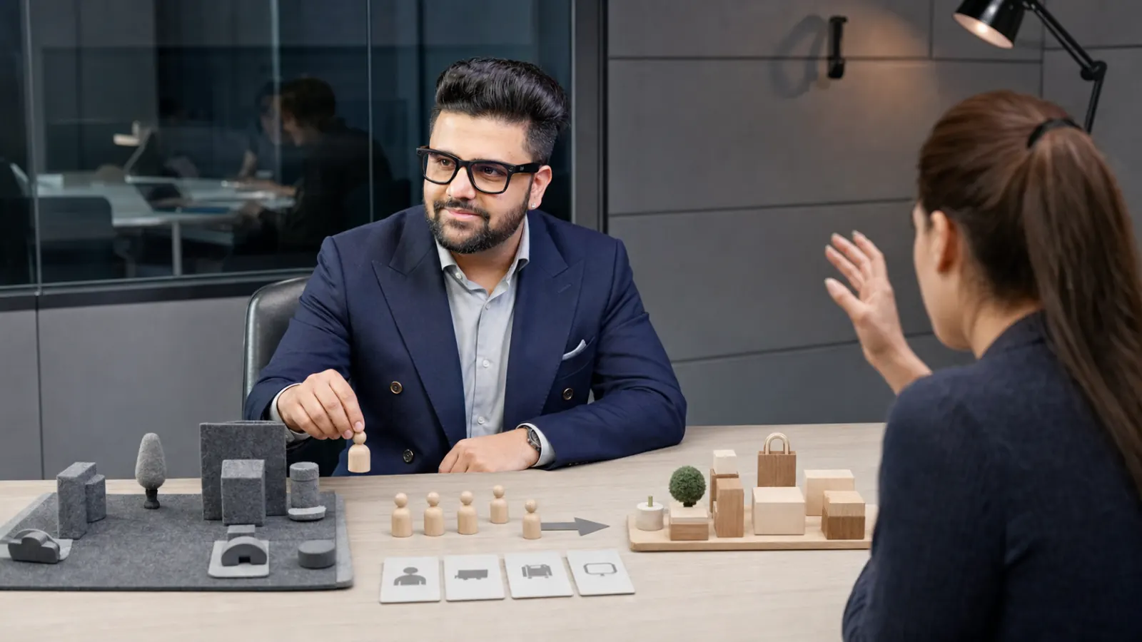 Sahil Khanna comparing unlabeled scenario cards in a behavioral research lab for Competitor's customers