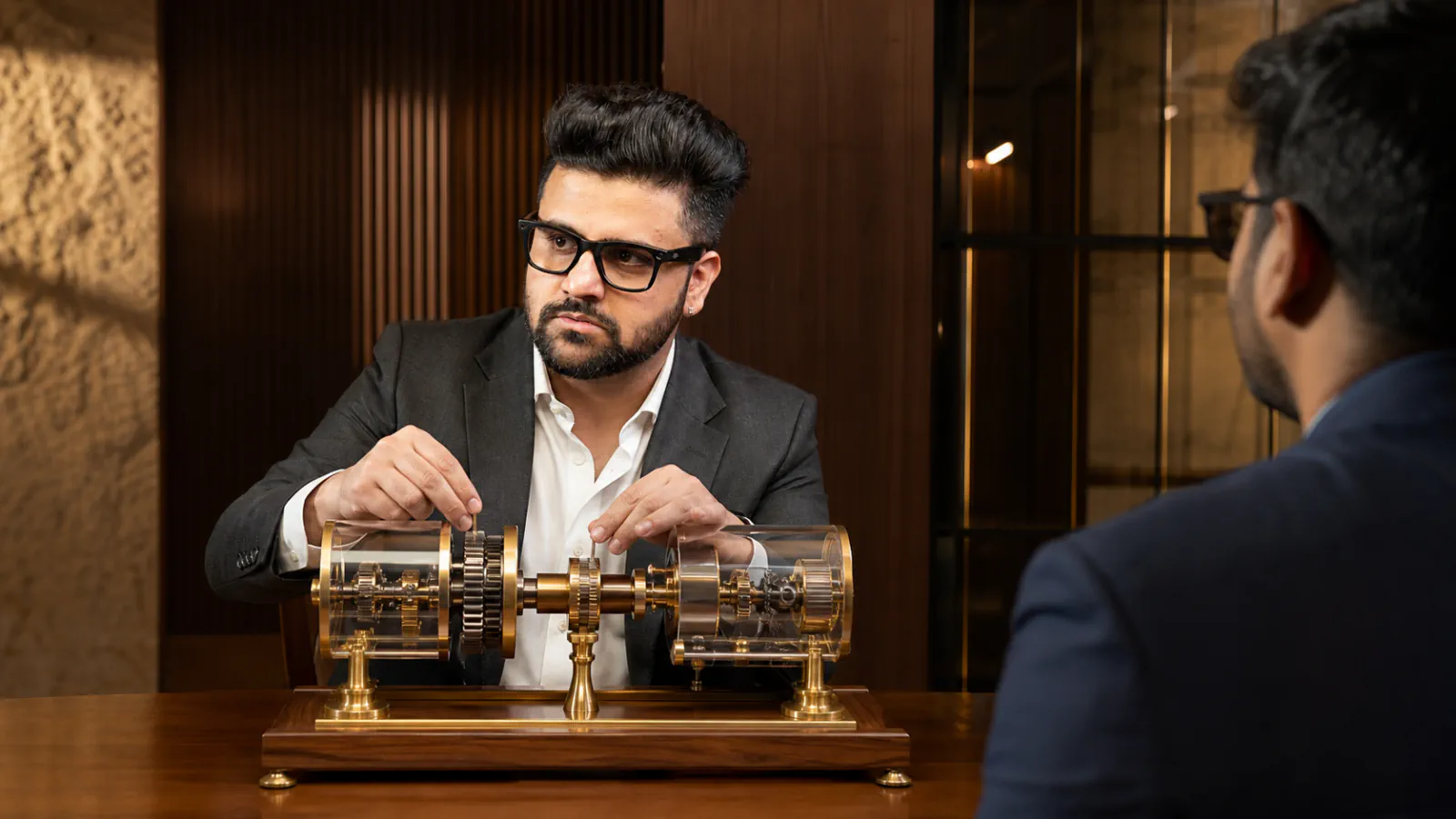Sahil Khanna mapping choices with brass markers in a project war room for Ulrich's leadership capital index